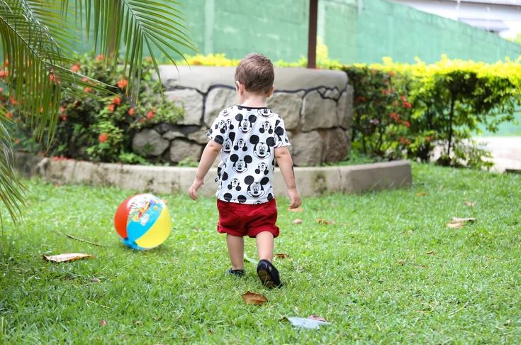 Toddler in the backyard with ball