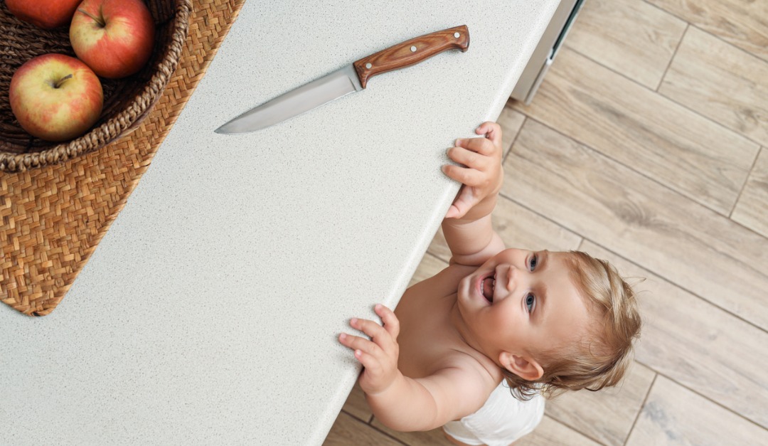 Toddler & Baby Proofing Kitchen - Baby Reaching For Objects On A Kitchen Counter